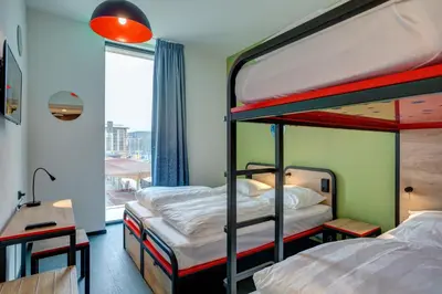two bunk beds in a room with a window at MEININGER Hotel Amsterdam Amstel in Amsterdam