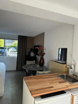 a kitchen with a sink and a table in a room at Chalet Parfait in Bergen