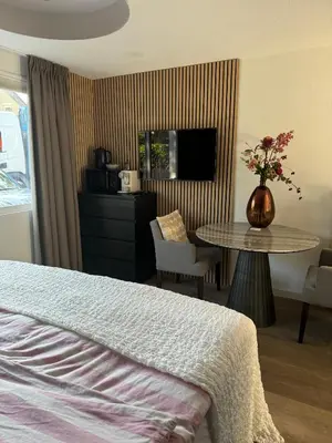 a hotel room with a bed and a table at Chalet Parfait in Bergen