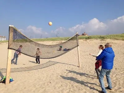 a group of people playing volleyball on the beach at Chalet Parfait in Bergen