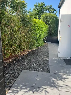 a door on a sidewalk next to a bush at Chalet Parfait in Bergen