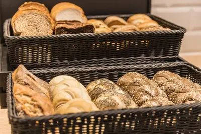 two baskets filled with lots of different types of bread at Holiday Inn - the niu, Dairy Haarlem in Haarlem