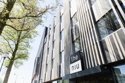 a building with a sign that reads the mno at Holiday Inn - the niu, Dairy Haarlem in Haarlem
