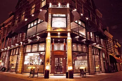 a building with a clock tower in front of it at Brasss Hotel Suites in Haarlem