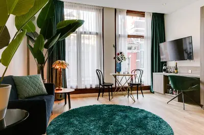 a living room with a couch and a table at Brasss Hotel Suites in Haarlem