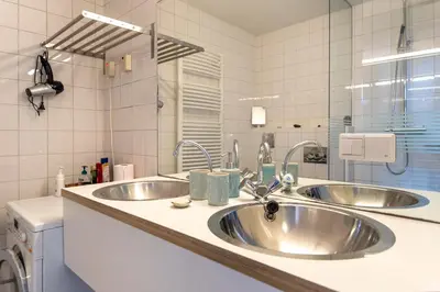 a kitchen counter with two sinks in a kitchen at Here's Lucy in Amsterdam