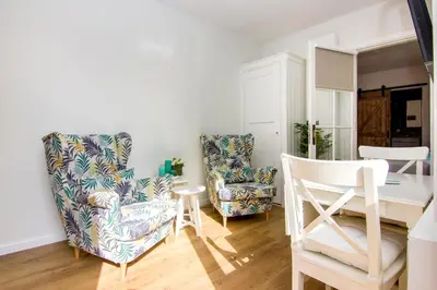 a living room with two chairs and a table at Lou-Lou in Zandvoort