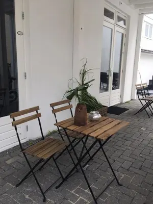 a picnic table and two chairs on a patio at appartementen zeespiegel in Zandvoort
