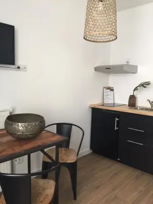 a kitchen with a table and a bowl on a table at appartementen zeespiegel in Zandvoort