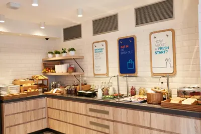 a kitchen with a counter with food on it at Holiday Inn Express Amsterdam - City Hall by IHG in Amsterdam