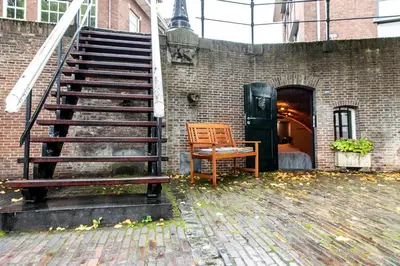 a staircase with a bench next to a brick building at UKI-Hotel in Utrecht