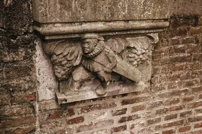 a stone statue of a man on a brick wall at UKI-Hotel in Utrecht