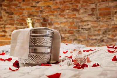 a bottle of champagne sitting on a table with a napkin at UKI-Hotel in Utrecht