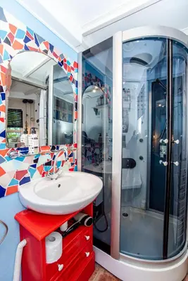 a bathroom with a sink and a shower at Jopie's Guesthouse in Zandvoort