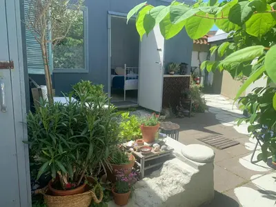 a patio with plants and a table in front of a house at Jopie's Guesthouse in Zandvoort