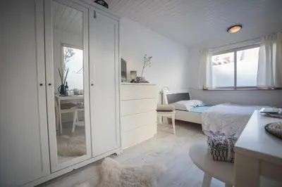 a small bedroom with a bed and a window at Jopie's Guesthouse in Zandvoort