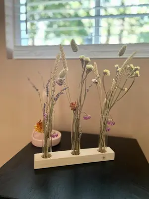 a row of vases filled with flowers on a table at Goditi La Vita in Hem