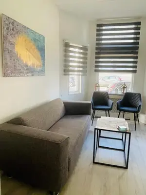 a living room with a couch and two chairs at SteR Appartement Zandvoort in Zandvoort