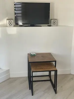 a table with a tv on top of a wall at SteR Appartement Zandvoort in Zandvoort