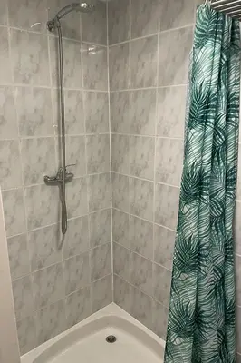 a shower with a shower curtain in a bathroom at SteR Appartement Zandvoort in Zandvoort