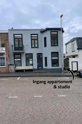 a white building with the words imaging apartment and studio at SteR Appartement Zandvoort in Zandvoort