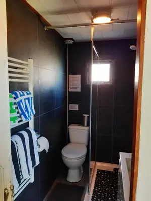 a small bathroom with a toilet and a sink at kitty