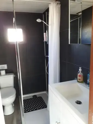 a bathroom with a shower and a toilet and a sink at kitty