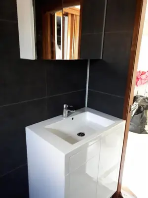 a white sink in a bathroom with a mirror at kitty