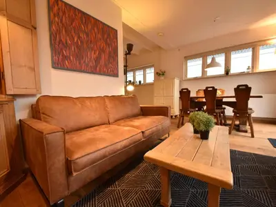 a living room with a brown couch and a table at Comfortable Holiday Home in Bergen in Bergen