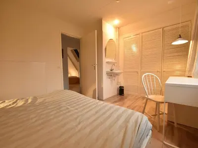 a bedroom with a bed and a table and a chair at Comfortable Holiday Home in Bergen in Bergen