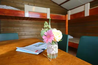a vase filled with flowers sitting on a table at Camping Recreatiepark Aalsmeer in Aalsmeer