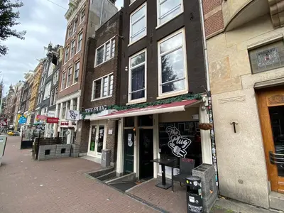 a building on a city street with a store at Hostel Utopia in Amsterdam