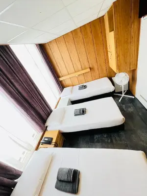 a small room with two beds and a window at Hotel Sharm in Amsterdam