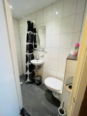 a small bathroom with a toilet and a sink at Hotel Sharm in Amsterdam