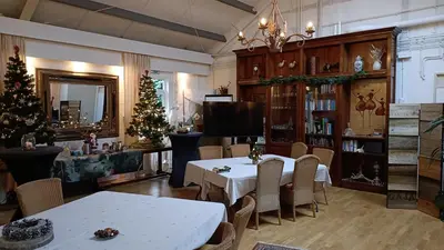 a dining room with a table and a christmas tree at Marenhoeve in Houten