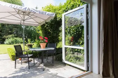 a patio with a table and chairs and an umbrella at Marenhoeve in Houten