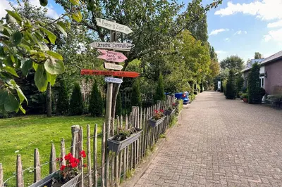 a street sign with many signs on a fence at Marenhoeve in Houten