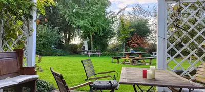 a patio with a table and chairs and a yard at Marenhoeve in Houten