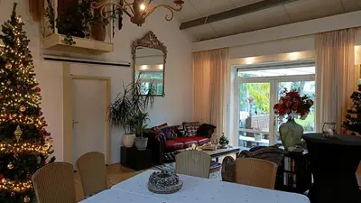 a living room with a christmas tree and a table at Marenhoeve in Houten
