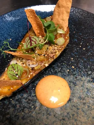 a slice of pizza on a blue plate with a egg at Slapen bij hofman in Alkmaar