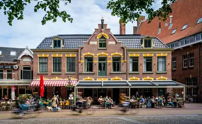 a group of people sitting outside of a building at Slapen bij hofman in Alkmaar
