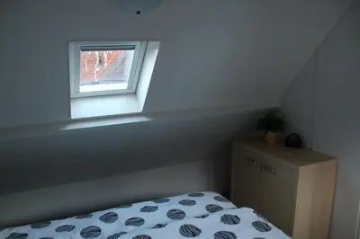 a bedroom with a bed and a window at Sea Star Egmond aan Zee in Egmond aan Zee