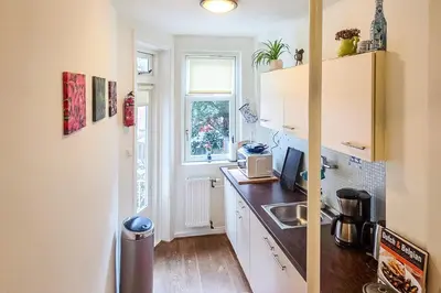 a small kitchen with a sink and a window at B&B West City Amsterdam in Amsterdam