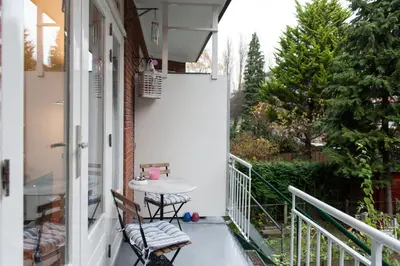 a balcony with a table and chairs on it at B&B West City Amsterdam in Amsterdam