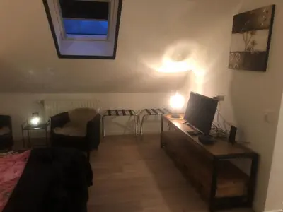 a bedroom with a bed and a desk with a computer on it at B&B Marialin in Wijdewormer