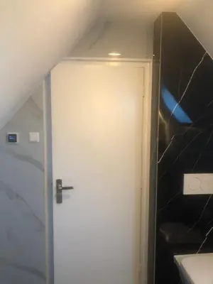 a white door in a room with a staircase at B&B Marialin in Wijdewormer