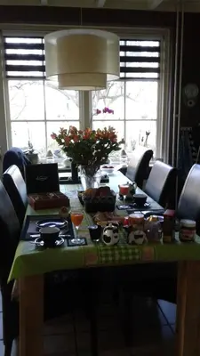 a table with food and drinks on top of it at B&B Marialin in Wijdewormer