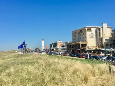 a city with cars parked in front of buildings at Es Vedra in Noordwijk aan Zee