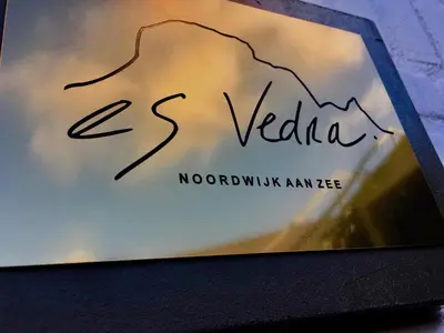 a book with a picture of a mountain on it at Es Vedra in Noordwijk aan Zee