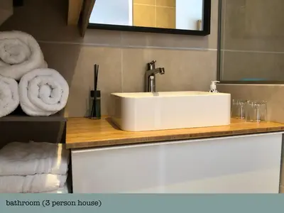 a bathroom with a sink and towels on a counter at Es Vedra in Noordwijk aan Zee